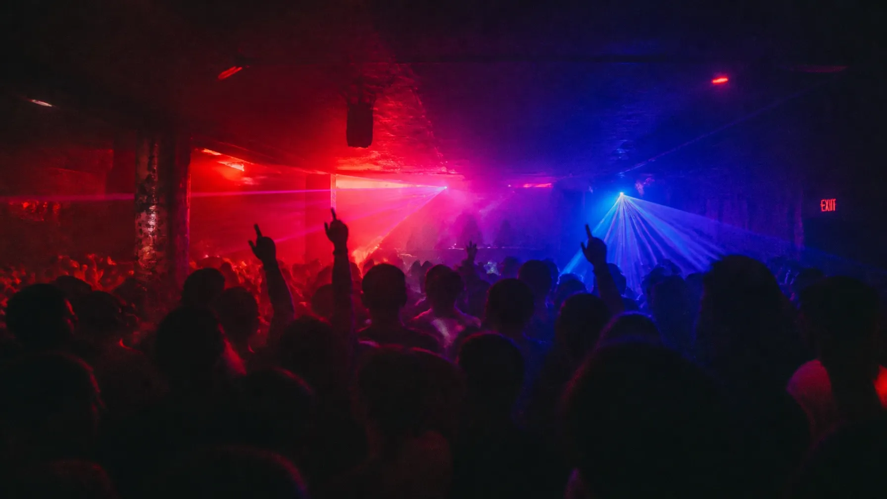 Crowd dancing under neon lights